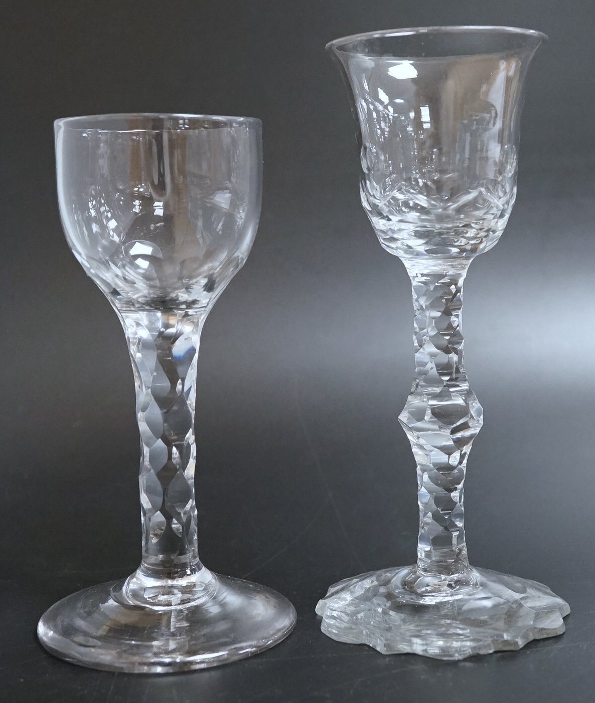Two faceted wine glasses, c.1775, one with faceted star cut foot, tallest 15cm